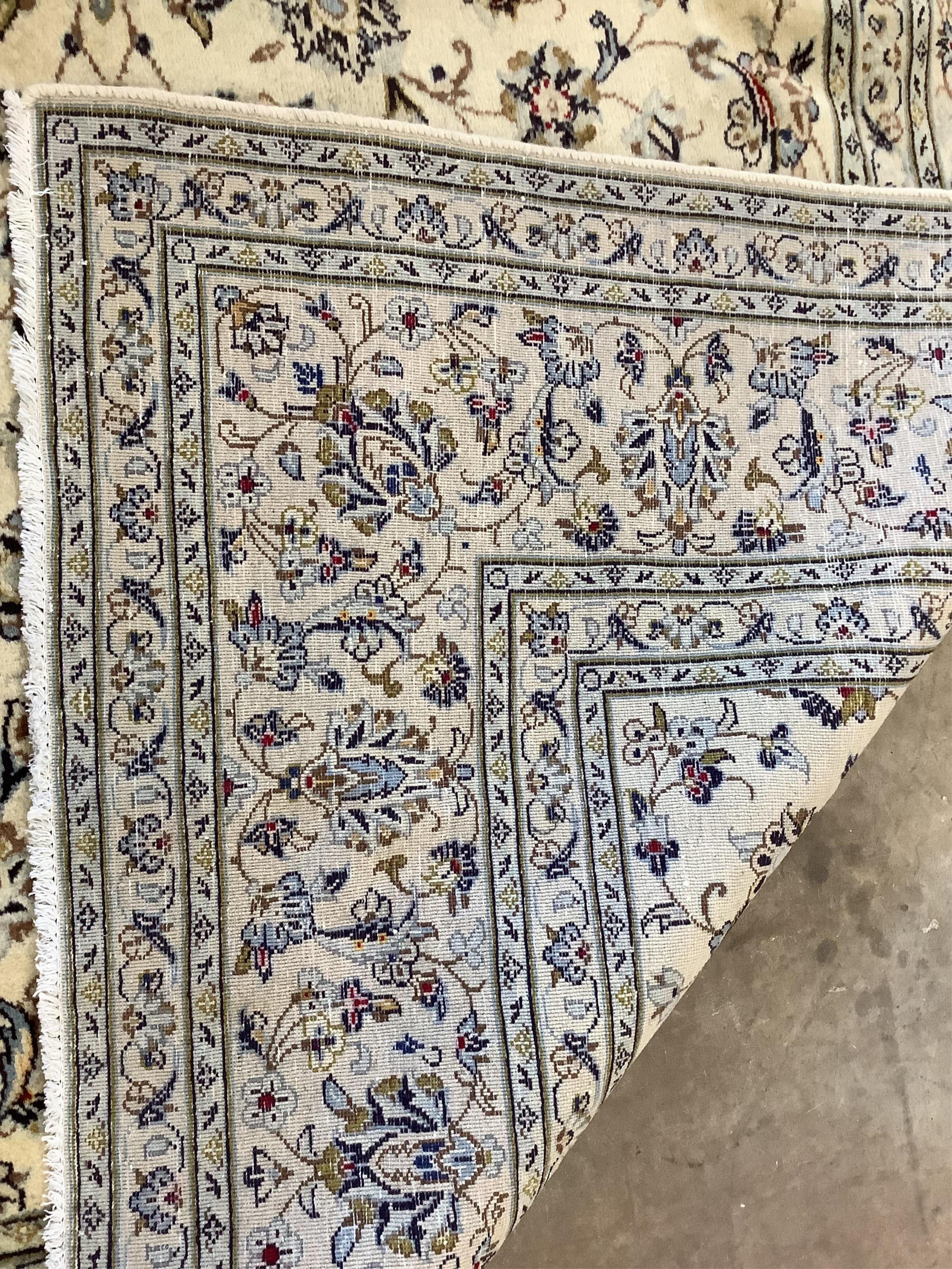 An ivory ground Kashan carpet, 305 x 196. Condition - good
